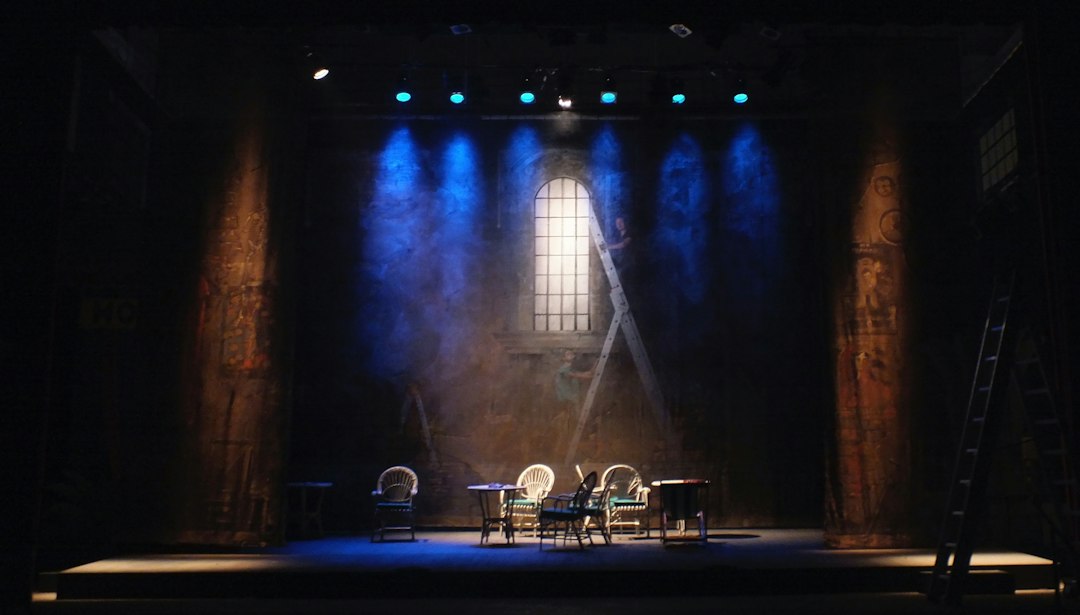 A theater stage lit by blue spotlights